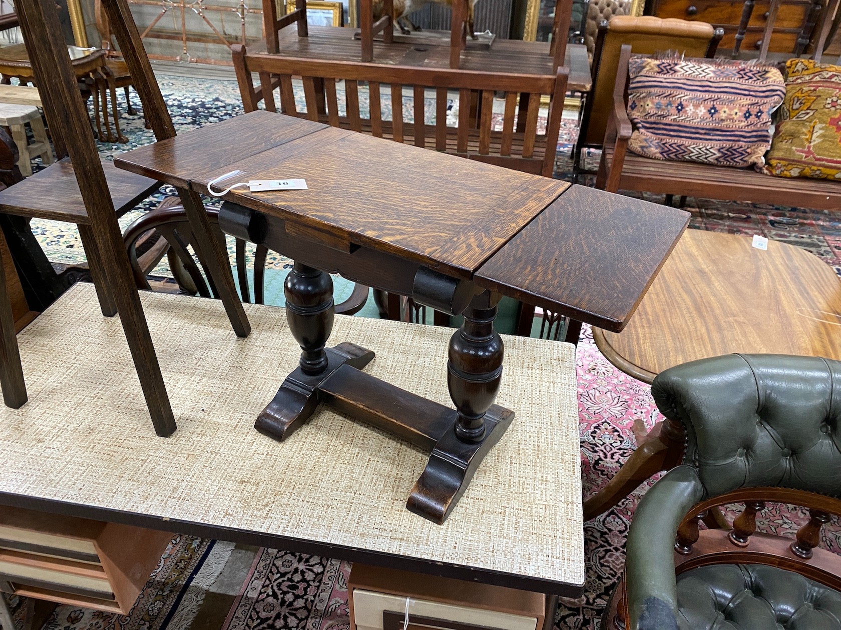 A 1920's small oak draw leaf occasional table, width 41cm, depth 29cm, height 44cm together with an Edwardian oak two tier plant stand